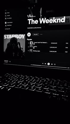 a laptop computer sitting on top of a desk in black and white with the screen turned off