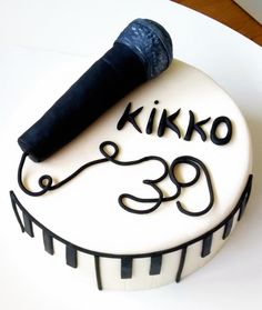 a white cake with black icing and a fondant topper that says kiko