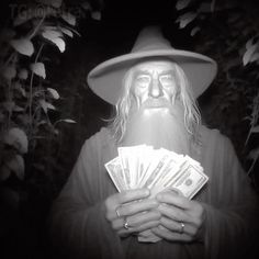 a man with long white hair wearing a hat and holding stacks of money in his hands