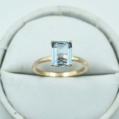 a ring with an aqua blue topazte in it