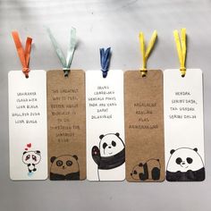 three tags with pandas and panda bears on them are hanging from the side of a table