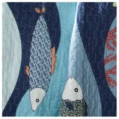 two fish on a blue and white quilt