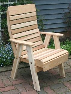 a wooden chair sitting on top of a brick patio