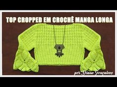 the top cropped in crochet magnana longa is shown with an owl pendant