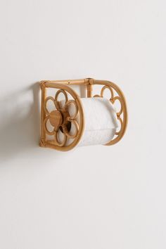 a bamboo toilet roll holder on the wall