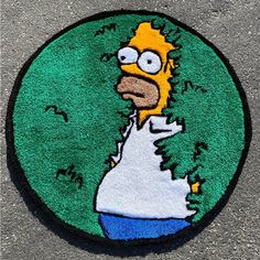 a rug with the image of homer from the simpsons is on the ground in front of a sidewalk