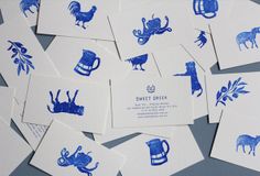 several blue and white cards with images of animals, birds, and coffee mugs on them