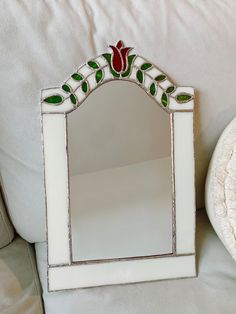 a mirror sitting on top of a white couch