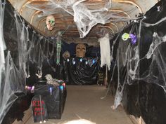 the inside of a van decorated for halloween with spider webs and skulls on it