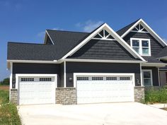 a black and white house with two garages