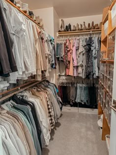 a closet full of clothes and shoes with shelves filled with shirts, pants and other items