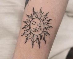 a sun tattoo on the arm with a woman's face