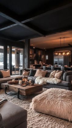 a living room filled with lots of couches and pillows on top of a rug