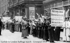 an old black and white photo of people holding signs