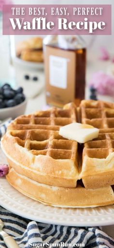 a stack of waffles sitting on top of a white plate next to blueberries