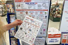 a woman holding up a newspaper in front of a sign that says hobby lorry