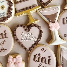 decorated cookies are arranged in the shape of heart, martini glass, and happy birthday