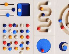 an assortment of wooden toys and magnets on a white surface with blue, red, orange, and yellow circles