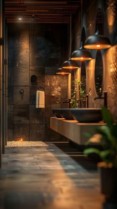 a bathroom with two sinks and lights on the wall above it, along with other fixtures