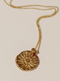 THE UNCONQUERABLE SUN NECKLACE FEATURES: * Inspired by the 16-pointed Sun of Vergina, the Unconquerable Sun necklace features four rays representing Fire, Water, Earth, and Air. Hand-carved from wax, its surrounding rays symbolize the twelve Olympian gods. With a trio of bails, this stylized coin reflects a luxurious past, appearing fractured and molten from years of wear. * Handmade in Vancouver from 24K gold vermeil (which is 3 microns thick of 24K gold plated over sterling silver). * Sterling Pendant Necklace Outfit, Pendant Necklace Simple, Greek Jewelry, Gold Sun, Charm Necklaces, Medallion Necklace, Jewelry Lookbook, Layering Necklace, Coin Necklace