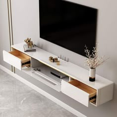 a white entertainment center with two drawers and a flat screen tv mounted on the wall