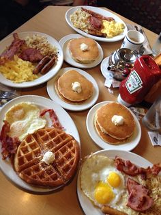 a table topped with plates of breakfast foods