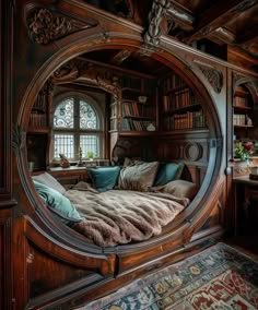 a large bed sitting under a window next to a book shelf filled with lots of books