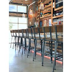 a row of chairs sitting in front of a bar