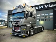 a large truck parked in front of a building