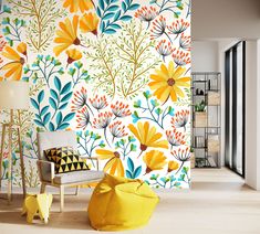 a yellow chair sitting in front of a colorful wallpaper