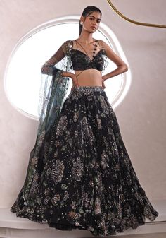 Unveil the epitome of sangeet sophistication with the Black Embroidered Lehenga. Crafted for the modern bride who seeks a blend of tradition and contemporary flair, this organza marvel glimmers with an embroidery of floral and paisley motifs. The lightweight yet voluminous lehenga is teamed with a modern uniquely cut strappy blouse. A sheer dupatta drapes gracefully, completing a look that's as enchanting as the night itself. Perfect for making your sangeet or cocktail night unforgettable Composition : Lehenga, Blouse, Dupatta - Organza Care: Dry Clean Only and Vacuum Storage This product can be customized for sleeves, length of blouse and neckline Delivery : 4-6 weeks as the product is hand crafted. Check Size Guide or choose MySize for free customisation (All Sizes above XL can be made a Astha Narang, Mahima Mahajan, Lehenga Style Saree, Cocktail Night, Lehenga Style, Embroidered Lehenga, Ruffled Blouse, Indian Wedding Wear