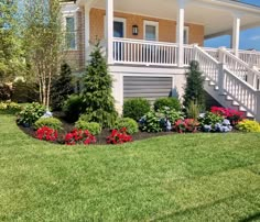 a house with flowers in the front yard