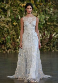 a woman in a wedding dress on the runway