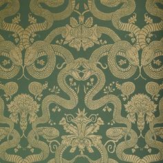 a green and gold wallpaper with an intricate design on it's side,