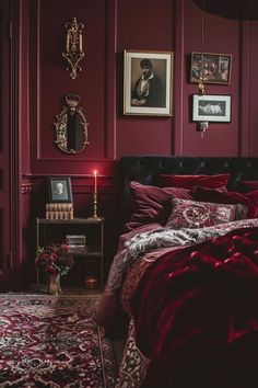 a bedroom with red walls and pictures on the wall