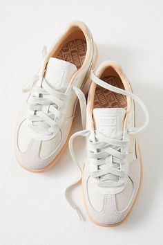 An 80s style returns in full force: these slim, tapered sneakers from Puma feature sleek leather uppers with a t-toe suede inlay and gum rubber outsole. **Features:** Low-top style, leather uppers, suede t-toe insert, side-stripe detail, logo tag, gum rubber outsole, lace-up closure **Why We | Puma Palermo Sneakers at Free People in Warm White/Alpine Snow, Size: US 9 Womens Everyday Shoes Sneakers, Cute Pumas Shoes, Suede Tennis Shoes, Sneaker Skirt Outfits Women, Low Top Shoes Women, Fall 2024 Sneaker Trends Women, Business Casual Outfits For Women Shoes, Shoes Like Sambas, Free People Sneakers