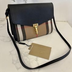 Burberry Derby Calfskin House Check Small Macken Crossbody Bag Black. New With Tags And Burberry Dust Bag Included. Measurements Base Length: 9.25 In Height: 7.25 In Width: 2.75 In Drop: 21 In (Adjustable) This Is An Authentic Burberry Grainy Calfskin House Check Small Macken Crossbody Bag In Black. This Sleek Crossbody Bag Is Crafted Of Textured Calfskin Leather In Black, With A Classic House Check Front Pocket. The Bag Features A Rear Zipper Pocket, A Long Adjustable Shoulder Strap, And Polish Burberry Purse, Burberry Shoulder Bag, Desi Fashion Casual, Crossbody Bag Black, Desi Fashion, Classic House, Black Cross Body Bag, Brown Suede, Burberry Bag