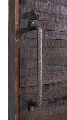 a close up of a wooden door with metal handles