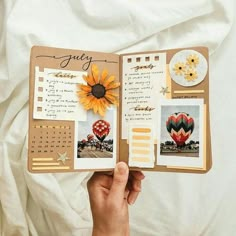 someone is holding up an open scrapbook with pictures and words on it, which are decorated with sunflowers