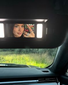 a woman taking a selfie in the back seat of a car