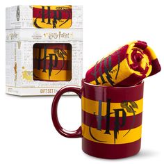 a harry potter mug with a towel wrapped around it in front of a boxed box