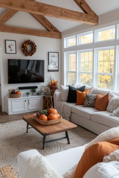 a living room filled with furniture and a flat screen tv mounted on a wall above a fire place