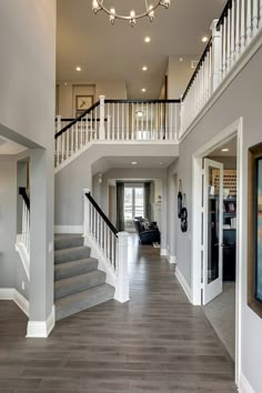 a large open floor plan with stairs leading up to the second story