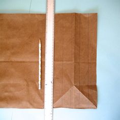 a piece of brown paper with a ruler next to it