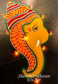 an elephant with lights on it's head in the shape of a sign that reads ganeshi