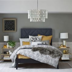 a bedroom with grey walls and yellow accents