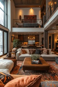 a living room filled with lots of furniture and large windows above it's floor to ceiling windows