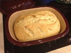 a loaf of bread sitting in a pan on top of a stove