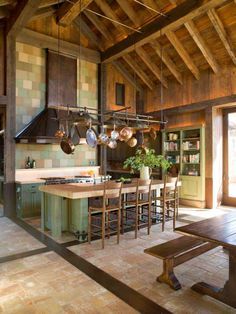 a large kitchen with wooden walls and flooring