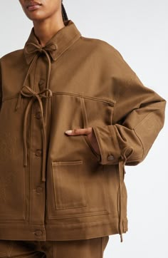 Back Jacket Design, Asymmetrical Jackets Women, Fall Cotton Washed Outerwear, Gen Z Workwear, Embroidered Cotton Outerwear For Streetwear, Chore Jacket Sewing Pattern, Oversized Embroidered Cotton Outerwear, Luxury Brown Cotton Utility Jacket, Transitional Clothing